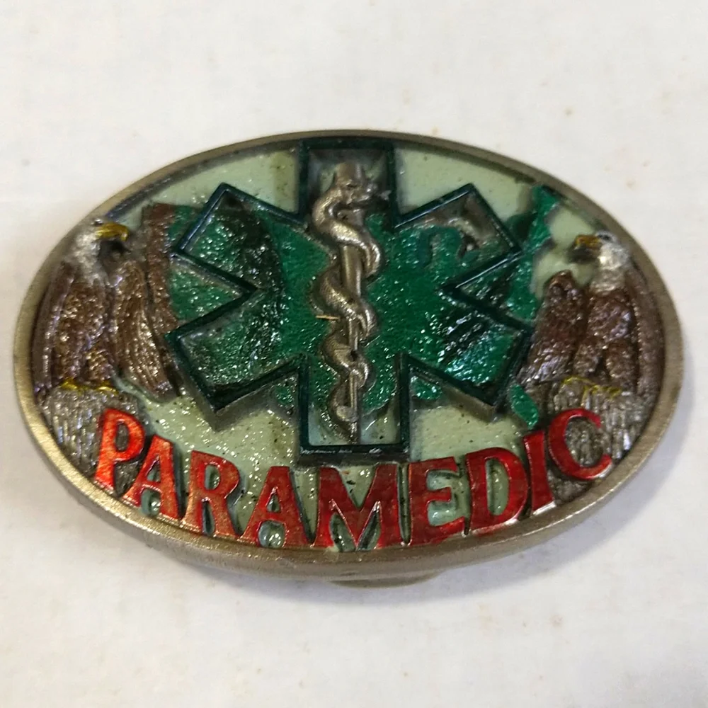 PARAMEDIC PEWTER BELT BUCKLE GREEN BACKGROUND 1986 USA